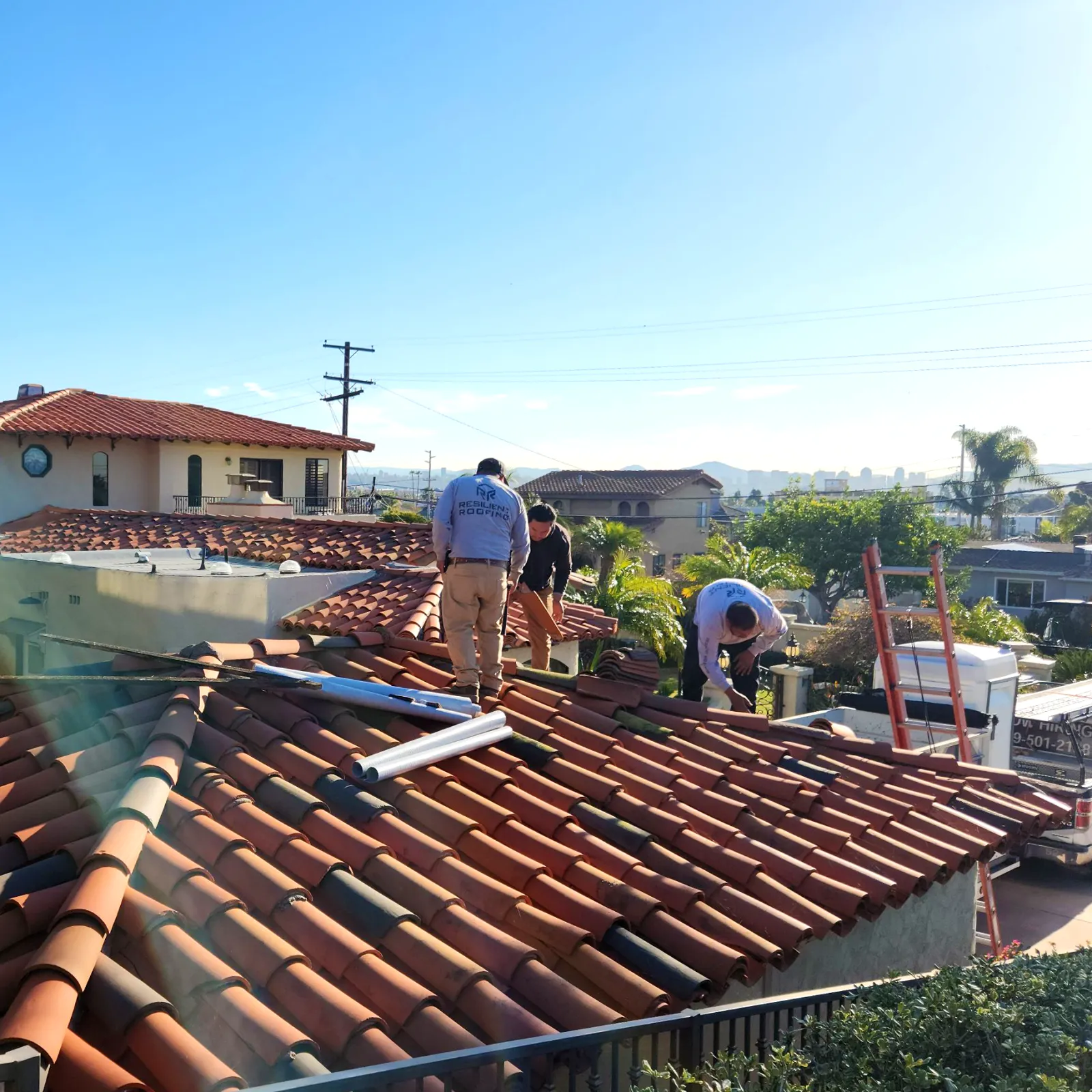 A Resilient Roofing crew installing a clay tile roof on a San Diego home.