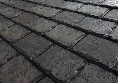 A black S-shaped barrel concrete tile roof showing its repeating wavy profile.