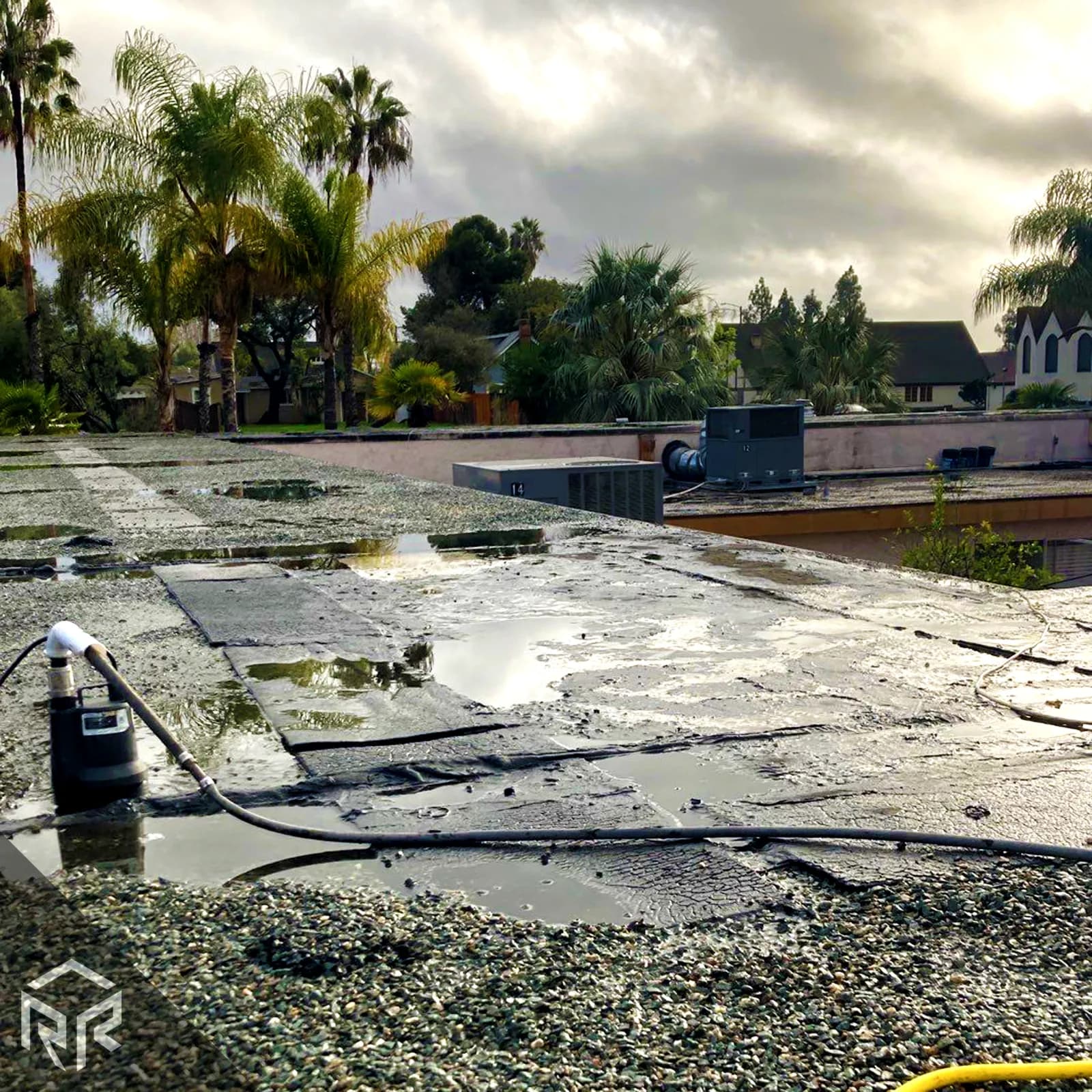 Standing water on a flat roof after a rainstorm in San Diego