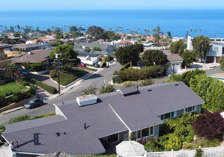 Aerial view of a San Diego coastal neighborhood, where salt air and marine-layer humidity influence roofing material choices and cost.
