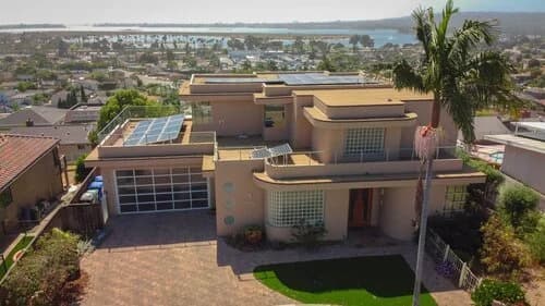 Aerial drone view of a modern San Diego home, the kind of imagery used to measure a roof accurately before a quote.